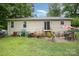 The backyard features a sliding door to the house and a patio with outdoor seating at 401 Yadkin St, Granite Quarry, NC 28072