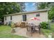 The backyard features a sliding door to the house and a patio with outdoor seating under an umbrella at 401 Yadkin St, Granite Quarry, NC 28072