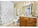 Updated bathroom featuring tile floor, vanity, and shower/tub combination at 401 Yadkin St, Granite Quarry, NC 28072