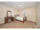 Bedroom with single bed, vanity table, carpet, and a window at 401 Yadkin St, Granite Quarry, NC 28072