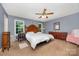 Large main bedroom with a ceiling fan, two windows, and carpeted floors at 401 Yadkin St, Granite Quarry, NC 28072