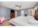 Comfortable bedroom featuring a ceiling fan, neutral-toned walls, and ample natural light at 401 Yadkin St, Granite Quarry, NC 28072