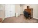 Neutral bedroom featuring closet with folding doors, an antique writing desk, and heater at 401 Yadkin St, Granite Quarry, NC 28072