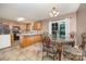 Open-concept dining area next to the kitchen, featuring a decorative table with seating and natural light at 401 Yadkin St, Granite Quarry, NC 28072