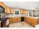 Bright kitchen featuring wood cabinetry, a window over the sink, tile floors, and a breakfast bar area at 401 Yadkin St, Granite Quarry, NC 28072