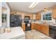 Bright eat-in kitchen featuring wooden cabinets, neutral countertops, and modern black appliances at 401 Yadkin St, Granite Quarry, NC 28072