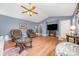 Comfortable living room showcasing hardwood floors, vaulted ceilings, and classic decor with ample seating and natural light at 401 Yadkin St, Granite Quarry, NC 28072