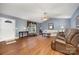 Spacious living room with hardwood floors, a vaulted ceiling, and a window letting in light for relaxation at 401 Yadkin St, Granite Quarry, NC 28072