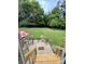 Spacious fenced backyard with a patio and mature trees, perfect for outdoor entertaining at 401 Yadkin St, Granite Quarry, NC 28072