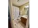 Full bathroom featuring a vanity, toilet, and bathtub with a shower, decorated with a floral shower curtain at 401 Yadkin St, Granite Quarry, NC 28072