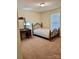 Cozy bedroom with carpet flooring, a vintage vanity and mirror, and a double bed with a floral quilt at 401 Yadkin St, Granite Quarry, NC 28072