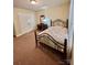 Bedroom with carpet flooring, a double bed, and a closet providing ample storage space at 401 Yadkin St, Granite Quarry, NC 28072