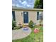 Close-up of the home's entrance, featuring a blue front door and manicured landscaping at 401 Yadkin St, Granite Quarry, NC 28072