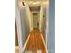 Hallway featuring wood-look flooring and neutral-toned walls, illuminated by a ceiling light fixture at 401 Yadkin St, Granite Quarry, NC 28072