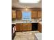Traditional kitchen with warm wood cabinets, a double sink, and a window with natural light at 401 Yadkin St, Granite Quarry, NC 28072