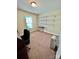 Home office featuring carpet floors, a window, and shelving, ideal for a workspace at 401 Yadkin St, Granite Quarry, NC 28072