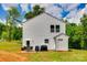 A backyard features a patio set, a grill, and a shed with a white exterior and a grassy lawn at 415 Kickapoo Ave, Gastonia, NC 28056