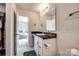 Bathroom with a single sink vanity, storage, and a view into the bedroom at 415 Kickapoo Ave, Gastonia, NC 28056