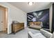 Bedroom featuring a space-themed mural, wooden crib, dresser and comfortable chair at 415 Kickapoo Ave, Gastonia, NC 28056
