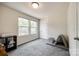 Bright bedroom featuring two windows for ample natural light and cozy gray carpeting at 415 Kickapoo Ave, Gastonia, NC 28056