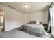Bright bedroom featuring large windows, neutral walls, and plush gray carpeting at 415 Kickapoo Ave, Gastonia, NC 28056