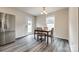Cozy dining room featuring a wooden table, stainless steel refrigerator, and neutral walls at 415 Kickapoo Ave, Gastonia, NC 28056