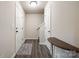 Inviting hallway with neutral walls, dark wood-look floors, and white trim at 415 Kickapoo Ave, Gastonia, NC 28056