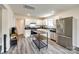 Well-lit kitchen with white cabinets, stainless steel appliances, and wood-look flooring at 415 Kickapoo Ave, Gastonia, NC 28056