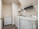 Well-organized laundry room with washer, dryer, freezer, and shelving for efficient storage at 415 Kickapoo Ave, Gastonia, NC 28056