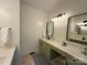 Bathroom vanity with dual sinks, modern fixtures and sage-green cabinets at 4230 Berry Hill Ct, Concord, NC 28025