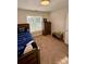 Bedroom features a twin bed, and a wooden dresser and bookshelf at 4230 Berry Hill Ct, Concord, NC 28025