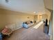 Bonus room with carpet, TV, and large sofa at 4230 Berry Hill Ct, Concord, NC 28025