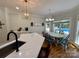 Open dining area with quartz countertops, stylish pendant lighting, and a view of the backyard pool at 4230 Berry Hill Ct, Concord, NC 28025