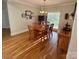 Well-lit dining room with a wooden table, chandelier, and views of the backyard at 4230 Berry Hill Ct, Concord, NC 28025