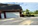 Attached two-car garage with white doors and a spacious driveway at 4230 Berry Hill Ct, Concord, NC 28025