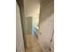 Hallway leading to bathroom with ceramic tile floor and white trim at 4230 Berry Hill Ct, Concord, NC 28025
