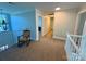 Upstairs hallway featuring neutral carpet and a rocking chair at 4230 Berry Hill Ct, Concord, NC 28025
