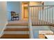 Upstairs hallway with carpet flooring, white railing and rocking chair at 4230 Berry Hill Ct, Concord, NC 28025