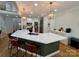 Bright kitchen island with seating, modern lighting, and breakfast bar in a stylish home at 4230 Berry Hill Ct, Concord, NC 28025