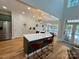 A contemporary kitchen with a large island, stainless steel appliances, and views of the pool at 4230 Berry Hill Ct, Concord, NC 28025