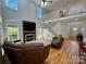 Spacious living room with fireplace, high ceilings, staircase, and large windows at 4230 Berry Hill Ct, Concord, NC 28025