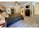 Spacious main bedroom offers a ceiling fan, dresser, sitting area, and access to an ensuite bathroom at 4230 Berry Hill Ct, Concord, NC 28025