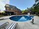 Backyard pool with brick home and pool house at 4230 Berry Hill Ct, Concord, NC 28025
