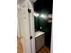 Stylish powder room features a modern vanity, updated light fixtures and green accent wall at 4230 Berry Hill Ct, Concord, NC 28025