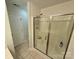 Walk-in shower with glass enclosure, tiled walls and a handheld shower head at 4230 Berry Hill Ct, Concord, NC 28025