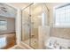 Bright bathroom features a glass enclosed shower and soaking tub at 5052 Ashley Pl, Bessemer City, NC 28016