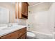 Bathroom with a wooden cabinet and tub at 5052 Ashley Pl, Bessemer City, NC 28016