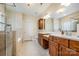 Elegant bathroom featuring double sinks, granite countertops, and a glass-enclosed shower at 5052 Ashley Pl, Bessemer City, NC 28016