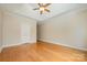 Empty bedroom with tray ceiling, hardwood floors, and double doors at 5052 Ashley Pl, Bessemer City, NC 28016