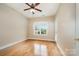 Bedroom features gleaming hardwood floors and a ceiling fan at 5052 Ashley Pl, Bessemer City, NC 28016